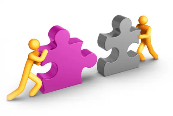 An illustration of two people pushing puzzle pieces together